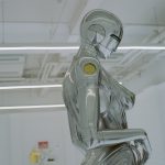 a robot sitting on a chair in a room