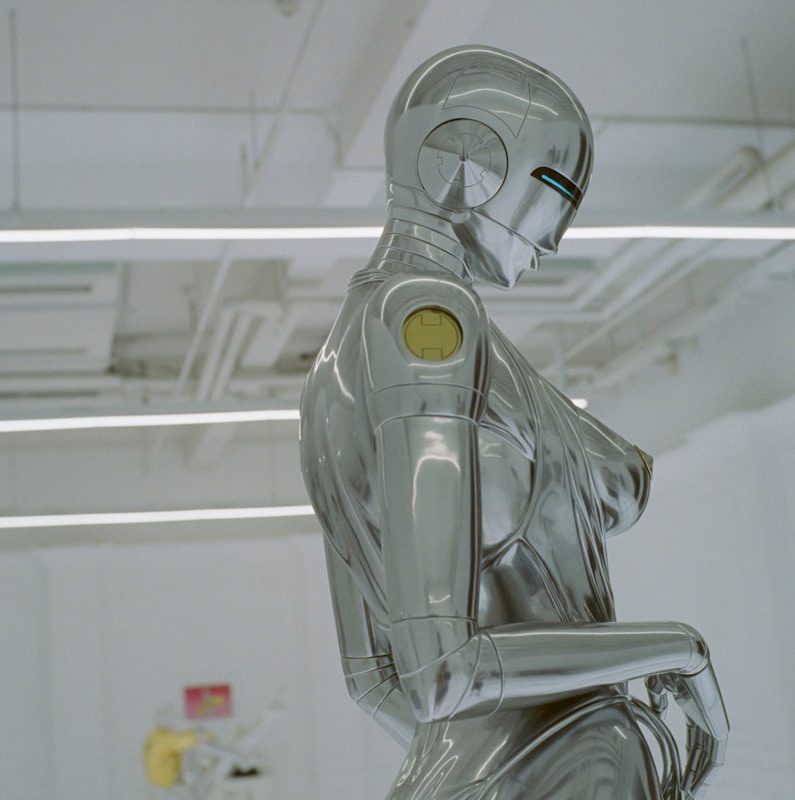 a robot sitting on a chair in a room