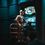 a man standing in front of a tv in a dark room